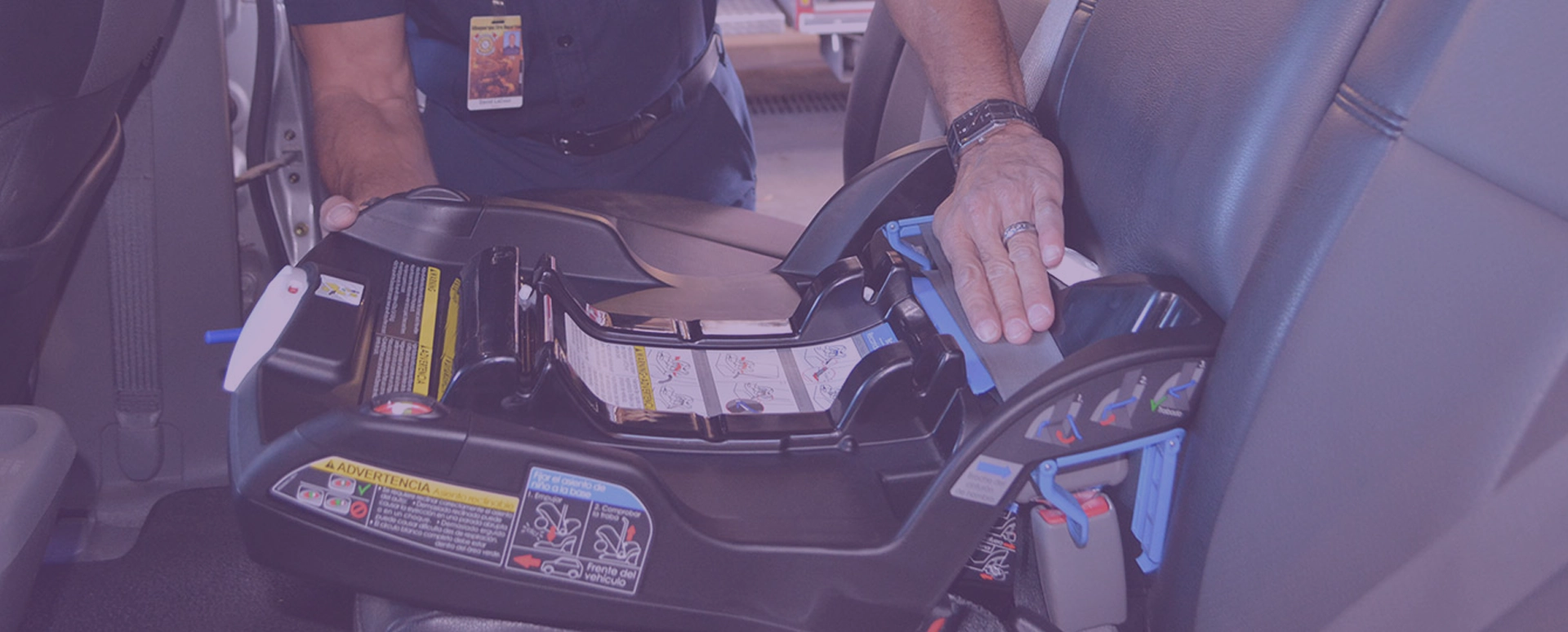 A police officer installs a child safety seat in a car A police officer installs a child safety seat in a car